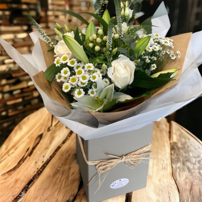 Thinking of You - This product is arranged in a hand-tied style contained in an aqua pack, delivered in a box right to your door with a personal touch. Simply neutral hand-tied. 