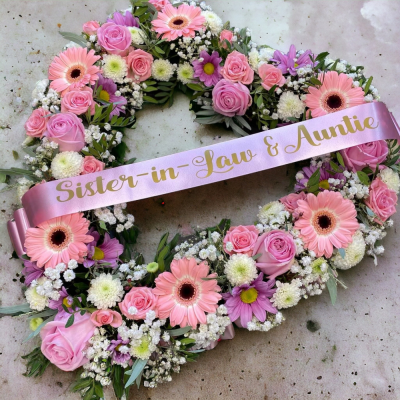 Mixed Floral Open-Heart - Suitable for funerals graves and memorials. This modern cluster design is perfectly balanced with a collection seasonal flowers, succulents, dried flowers and greenery. It is arranged on a wet floral foam shape base.