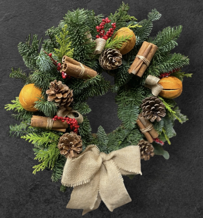 Traditional Wreath - A handcrafted traditional Christmas wreath featuring fragrant evergreens, pinecones, red berries, cinnamon bundles, dried orange slices, and a rustic hessian bow.