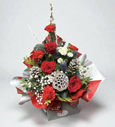Santa Baby - Santa Baby is a festive Christmas arrangement featuring red roses, carnations, white blooms, frosted pinecones, and winter thistles.