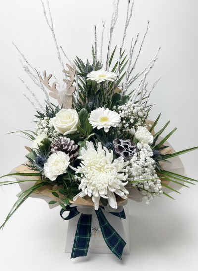 Silent Night - Silent Night is a serene winter arrangement featuring white roses, chrysanthemums, gerberas, frosted pinecones, snowy branches, and festive greenery.